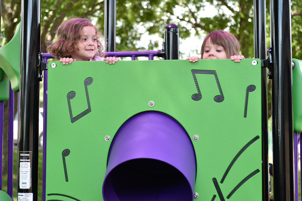 Children have fun on a newly built play area at Fred Moore Day Nursery School. Floyd Smith Concrete is the company that built the play area at Fred Moore Day Nursery School. The company is building it through a grant.